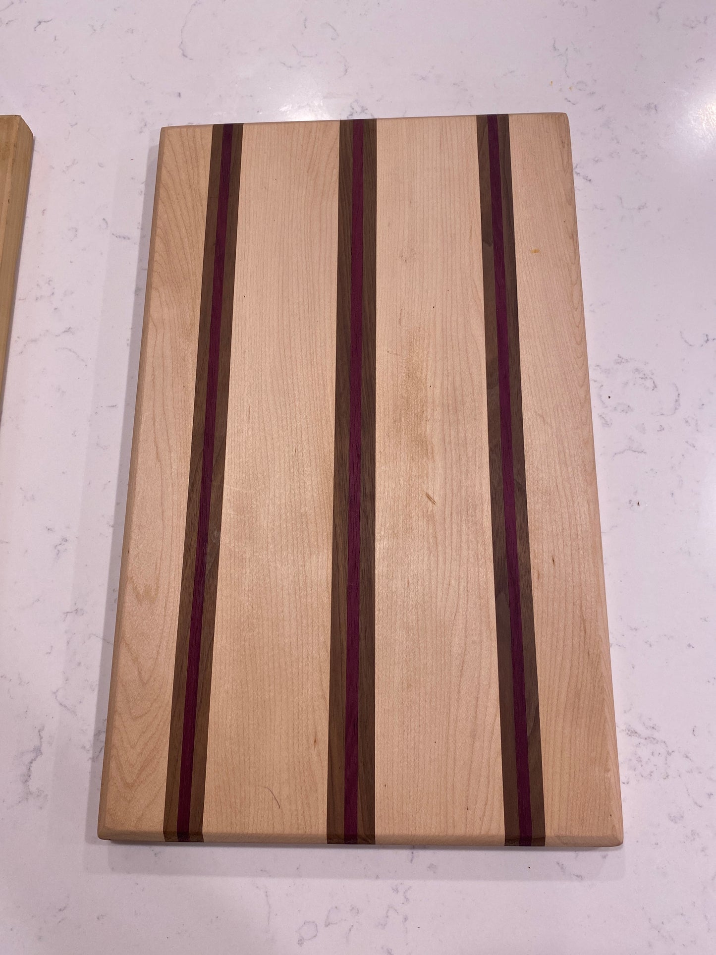 Maple with strips of black walnut and purple heart.